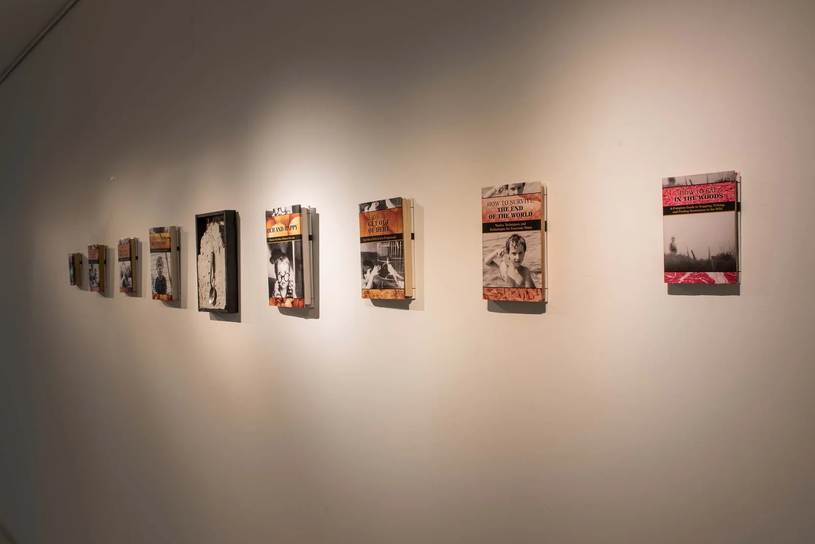 How to Love the Dust (2018) — books, photographs from artist’s archive, cement by Siniša Radulović