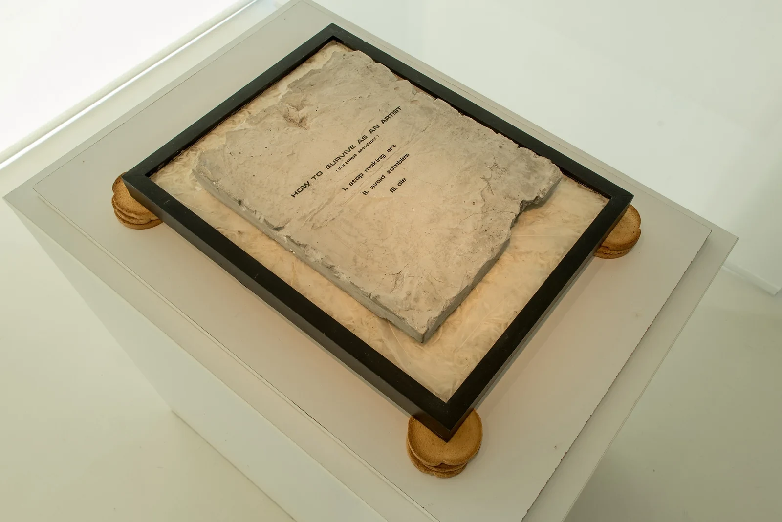 How to Survive (2018) — cement, feathers, Melba toast by Siniša Radulović